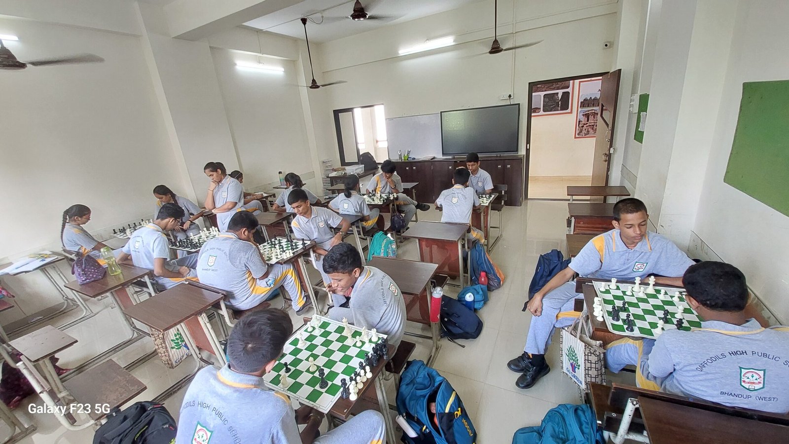 Chess academy students learning with their peers