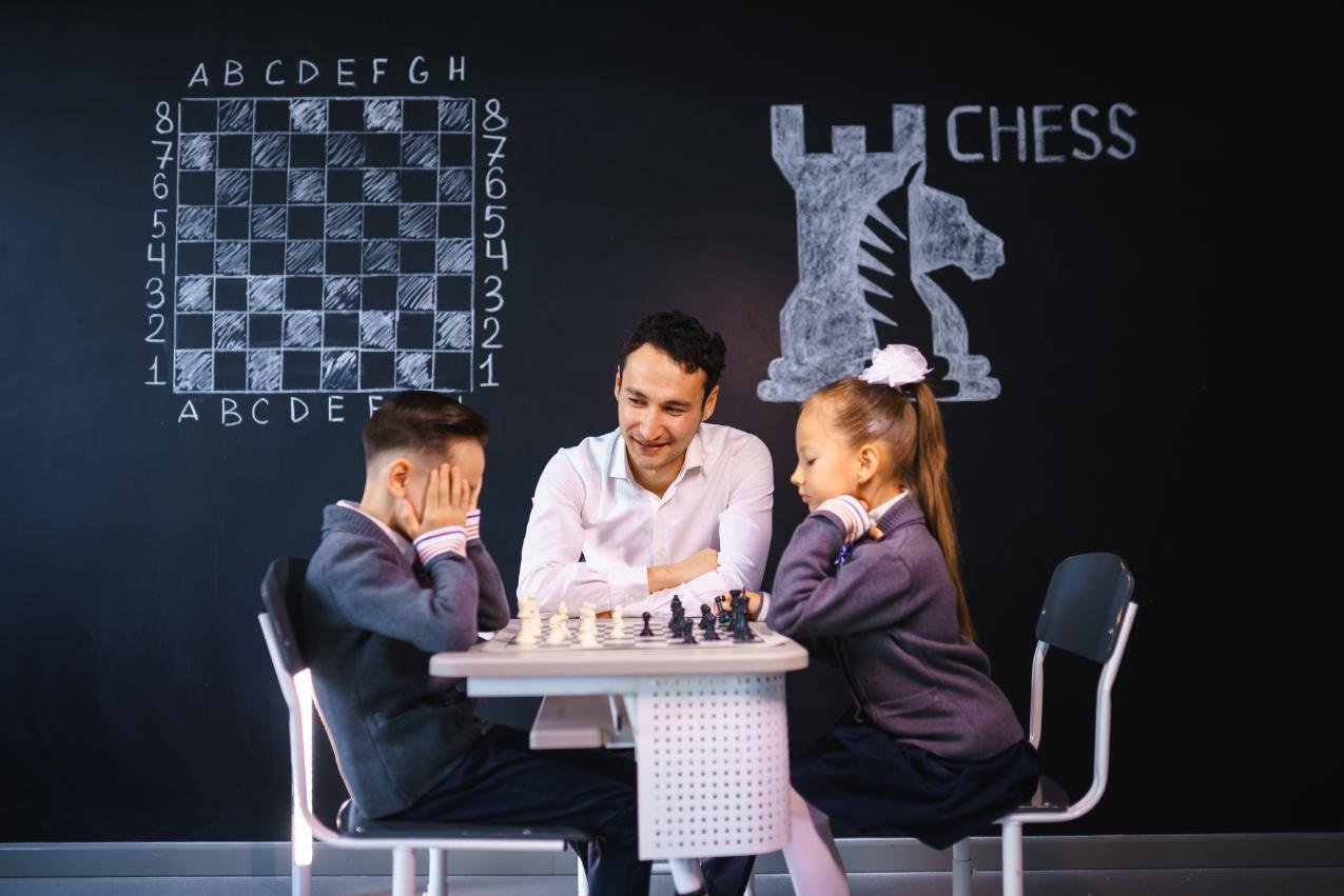 Experienced chess coach guiding kids