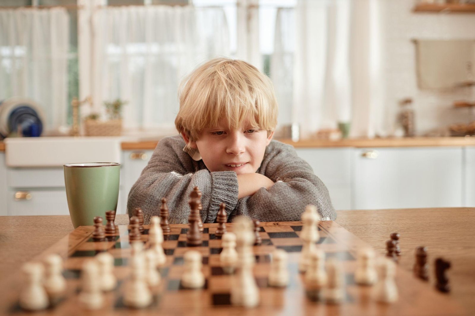 Parent and child playing chess together at home