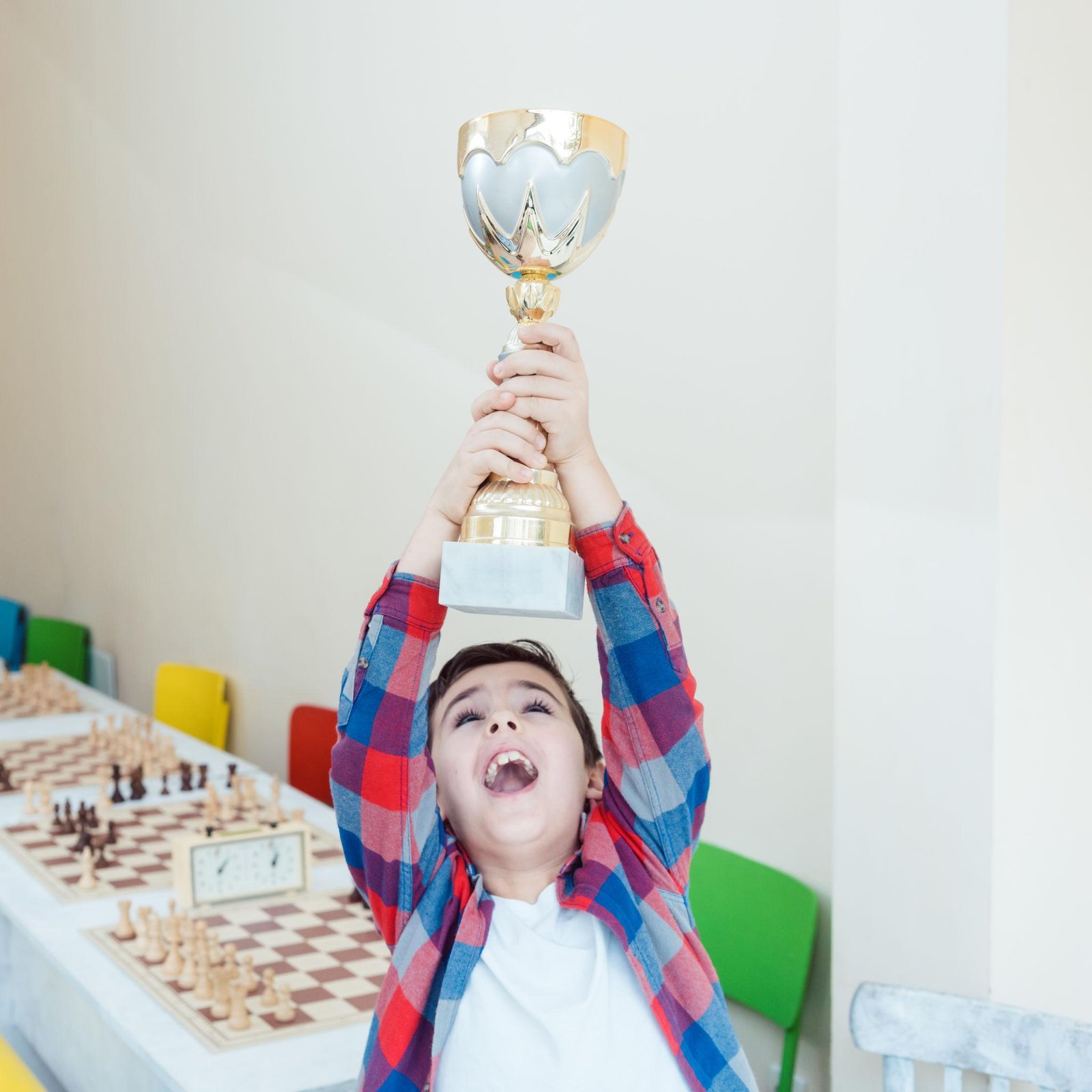 Young chess player smiling after tournament preparation